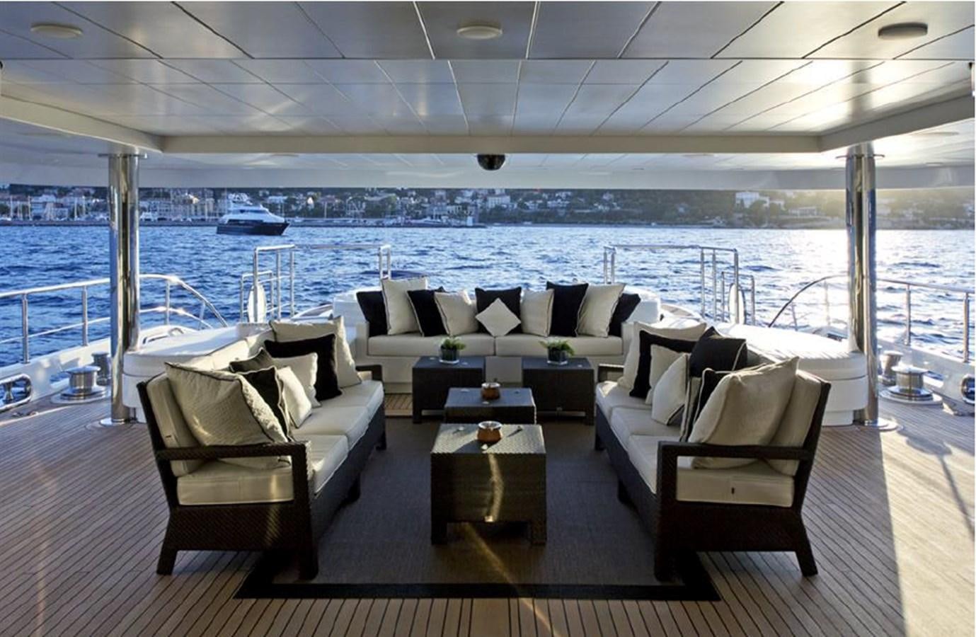 a room with a couch and a table and a view of the water aboard BELLA 2 Yacht for Sale