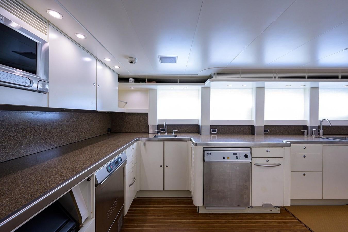 a kitchen with white cabinets aboard TEMPO REALE Yacht for Sale