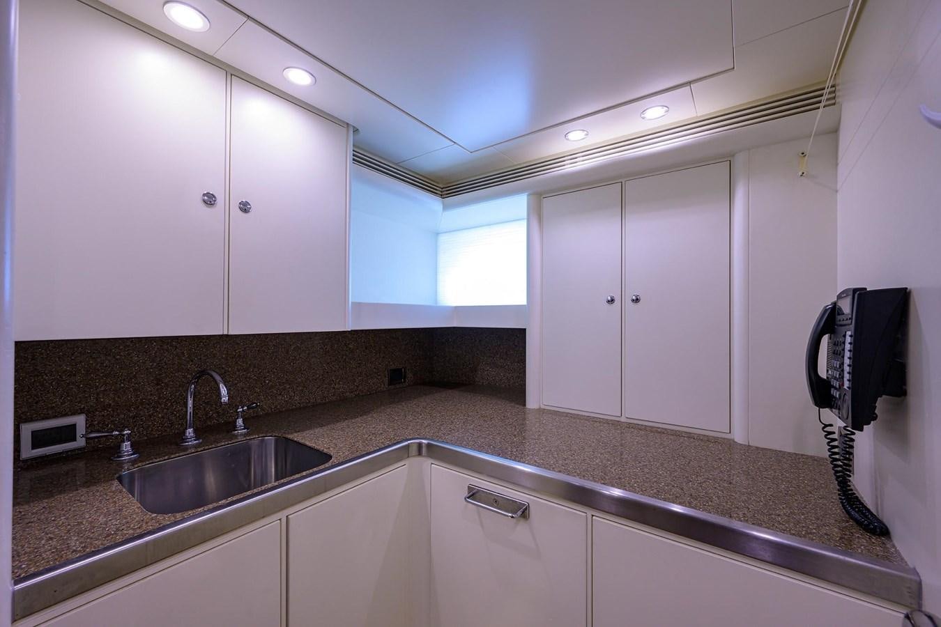 a kitchen with white cabinets aboard TEMPO REALE Yacht for Sale