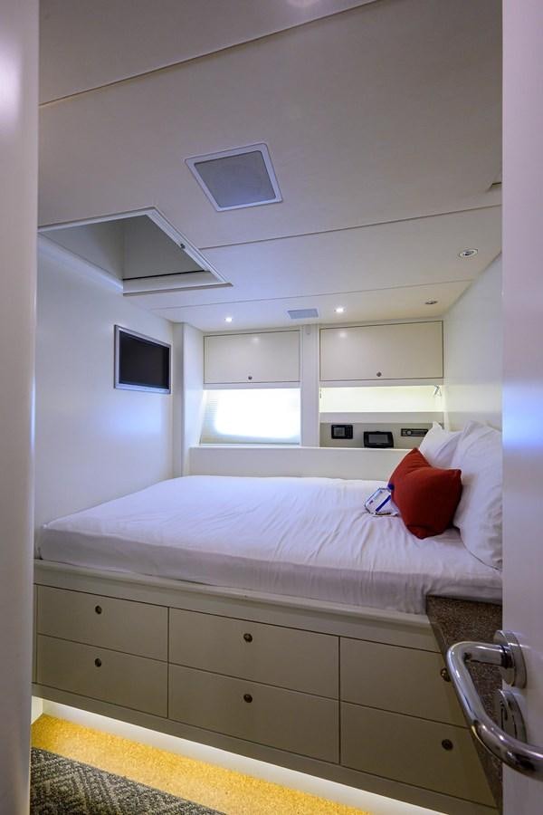 a room with a bed and a television on the wall aboard TEMPO REALE Yacht for Sale