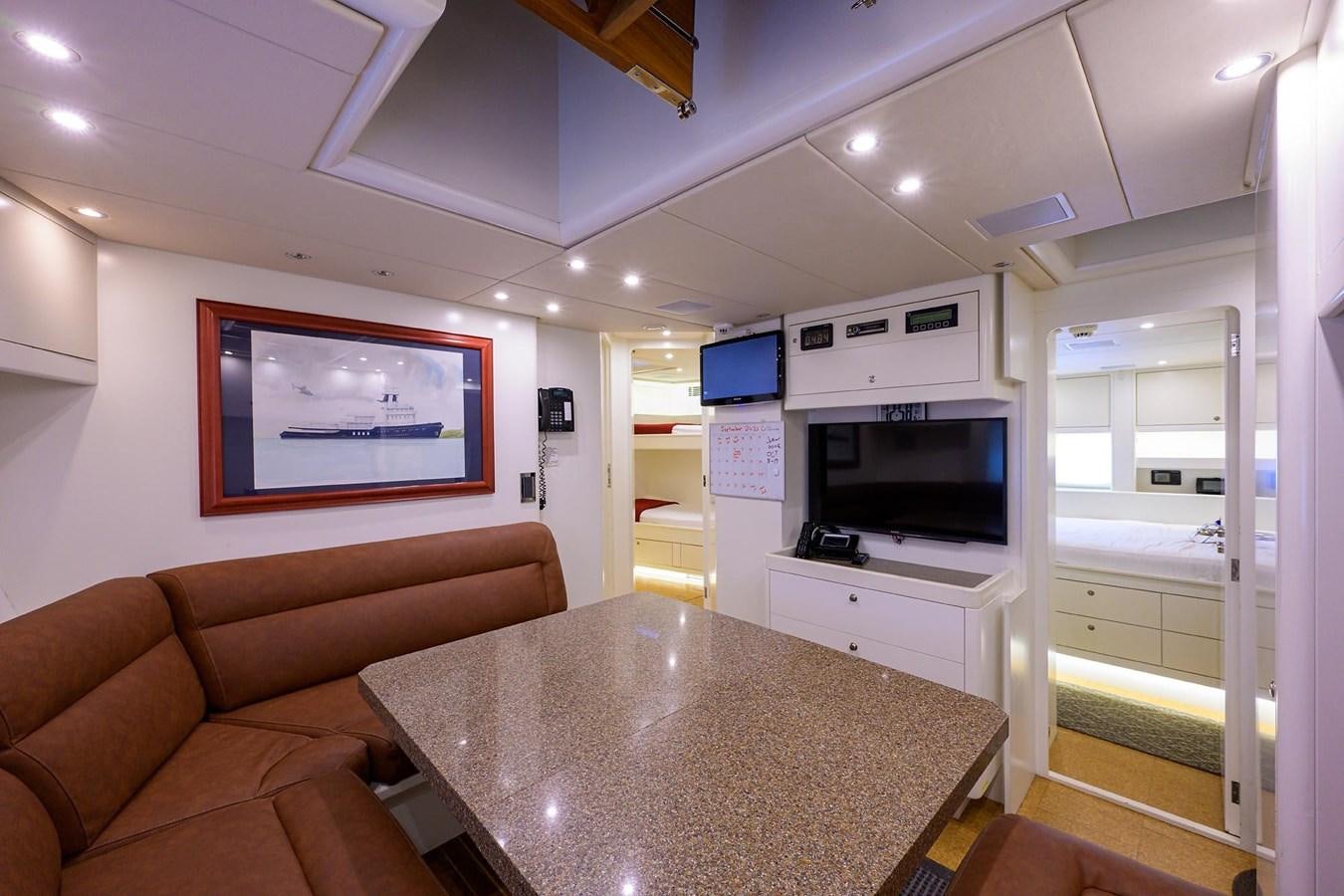 a living room with a table and chairs aboard TEMPO REALE Yacht for Sale