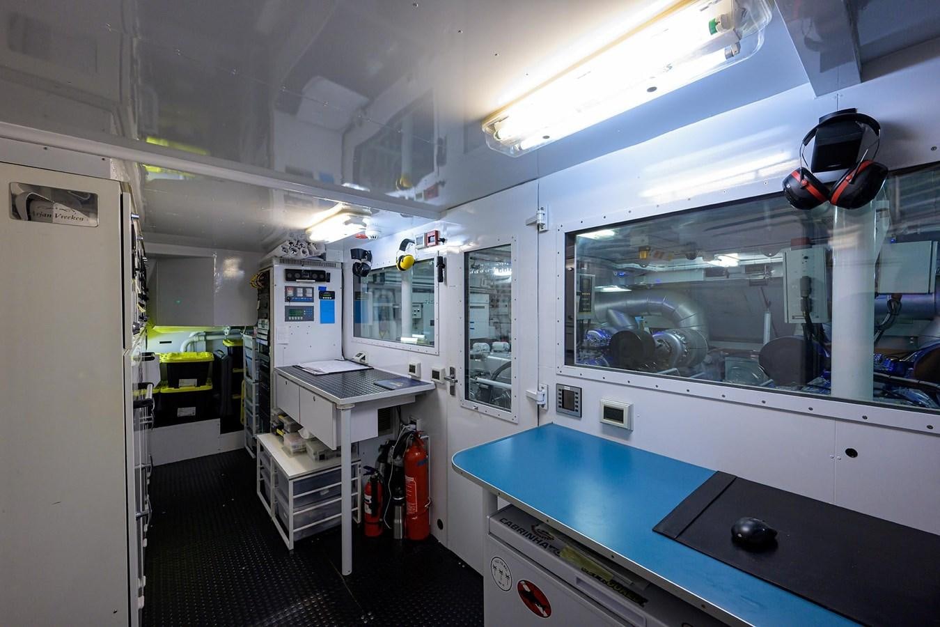 a room with a blue table and white cabinets aboard TEMPO REALE Yacht for Sale