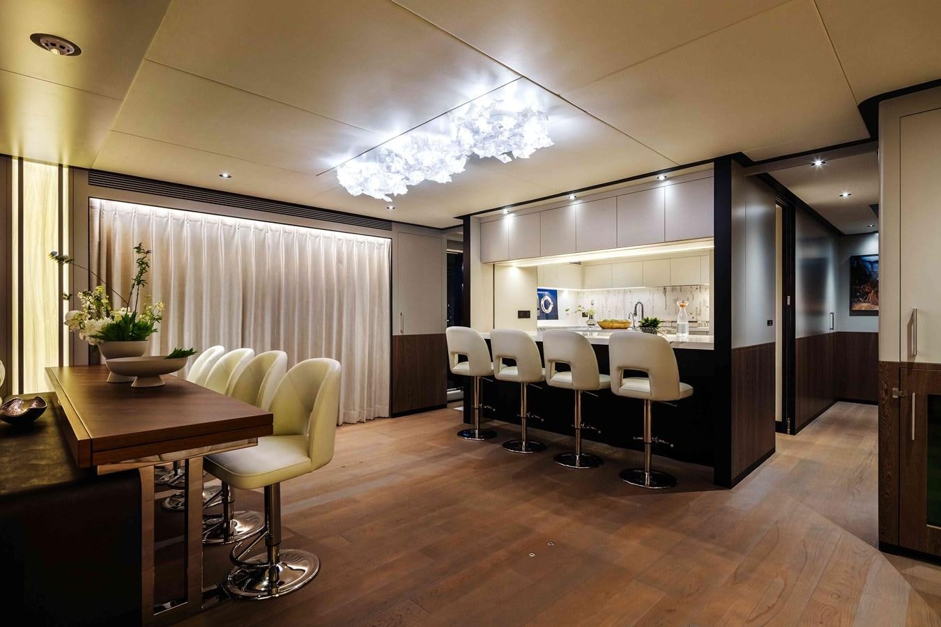 a room with tables and chairs aboard FD110-004 NEW ARRIVAL Yacht for Sale