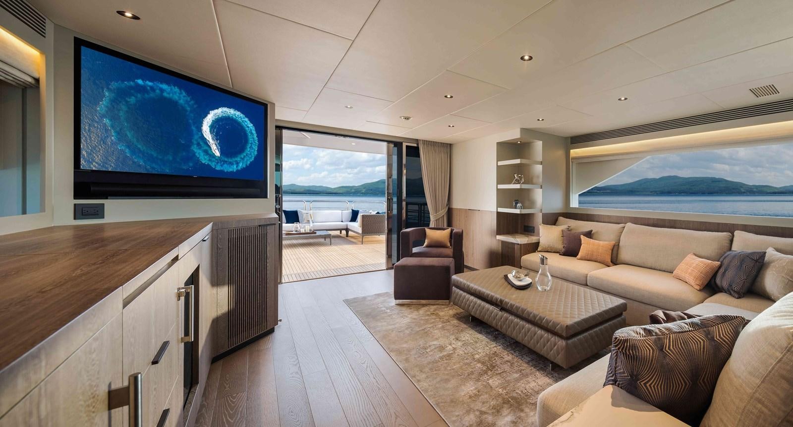a living room with a large screen aboard FD110-004 NEW ARRIVAL Yacht for Sale