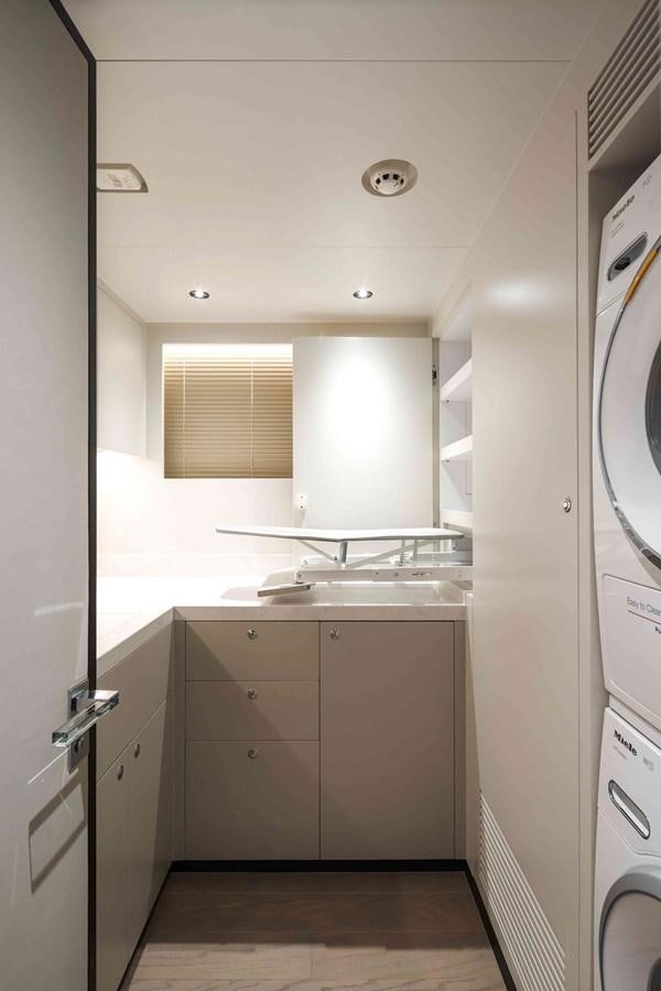 a kitchen with white cabinets aboard FD110-004 NEW ARRIVAL Yacht for Sale