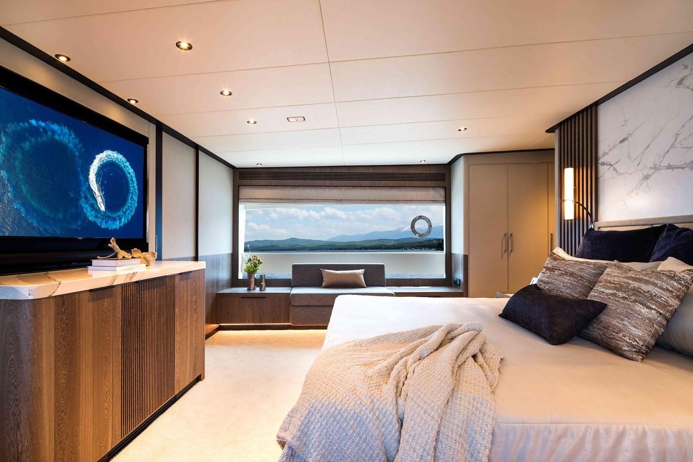 a bedroom with a large flat screen tv and a bed aboard FD110-004 NEW ARRIVAL Yacht for Sale