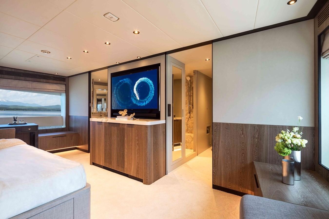 a room with a tv and a table aboard FD110-004 NEW ARRIVAL Yacht for Sale
