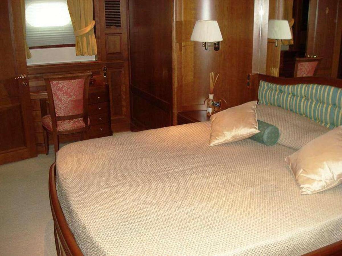 a bed with white sheets aboard ENIGMA Yacht for Sale