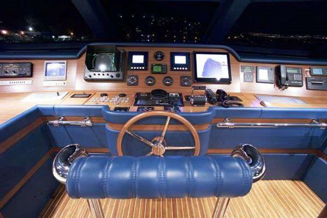 a wooden boat with a steering wheel aboard ENIGMA Yacht for Sale