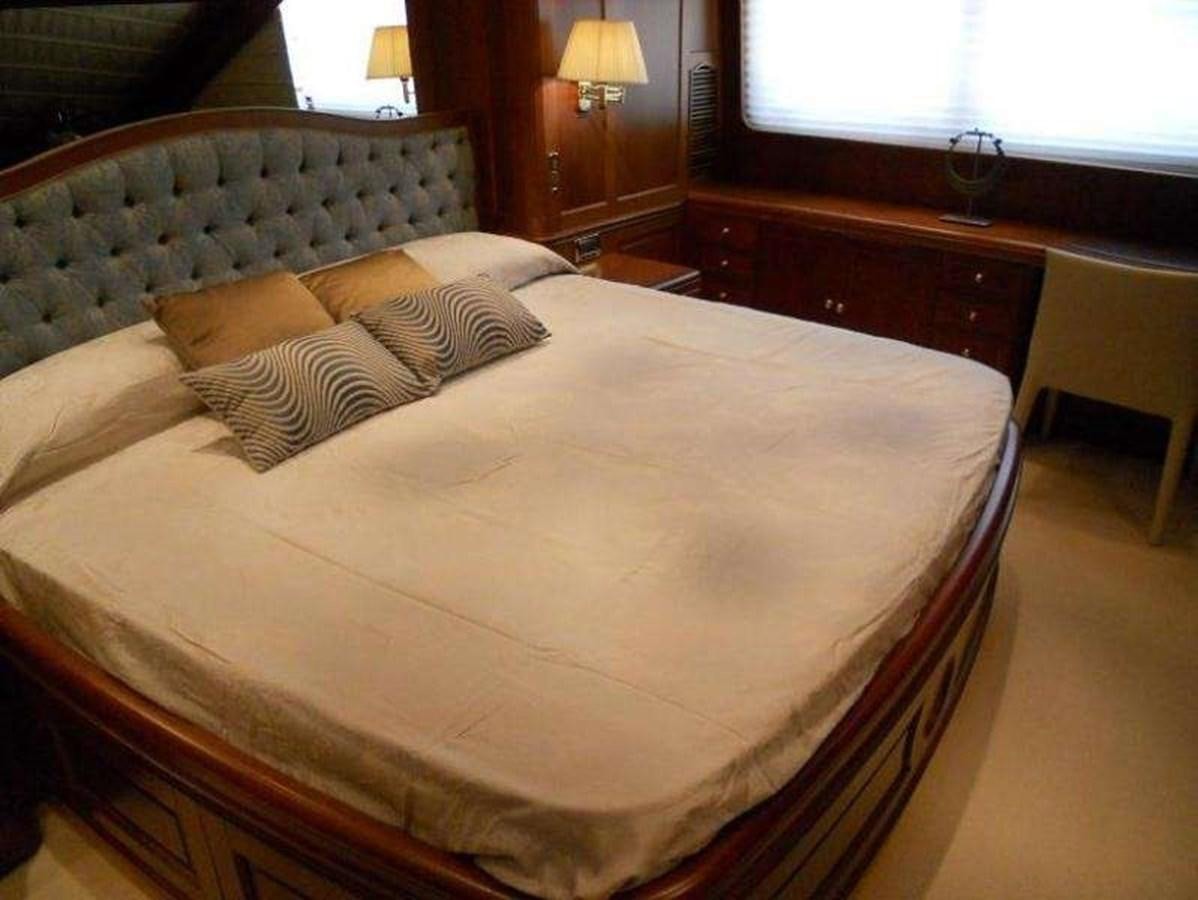 a bed with a white sheet aboard ENIGMA Yacht for Sale