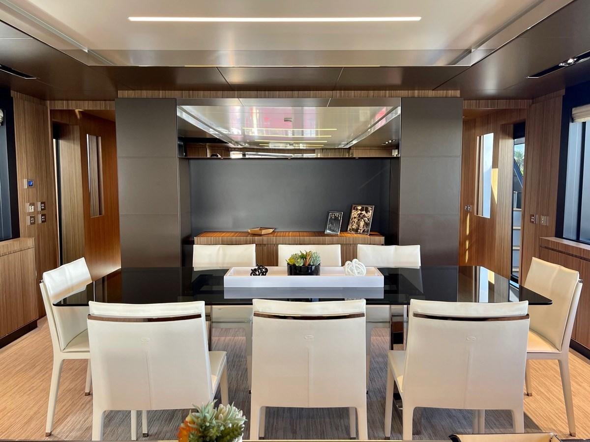 a room with tables and chairs aboard 100 RIVA CORSARO Yacht for Sale