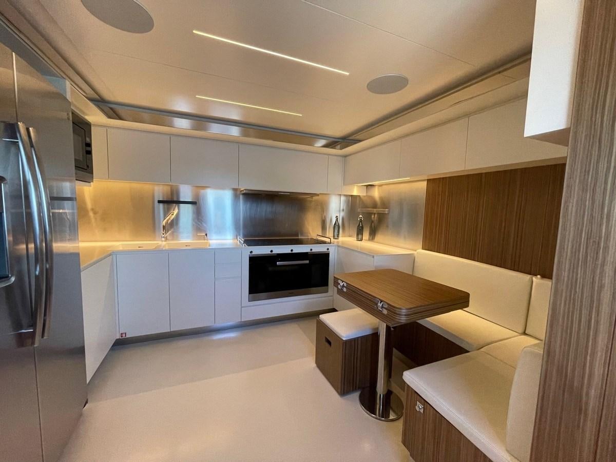a kitchen with white cabinets aboard 100 RIVA CORSARO Yacht for Sale