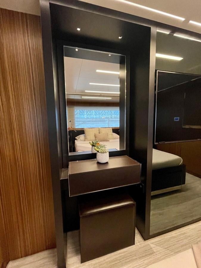 a room with a window and a table with a plant in it aboard 100 RIVA CORSARO Yacht for Sale