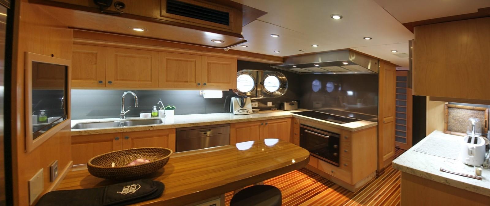 a kitchen with wooden cabinets aboard KOKOMO NIGHTS Yacht for Sale