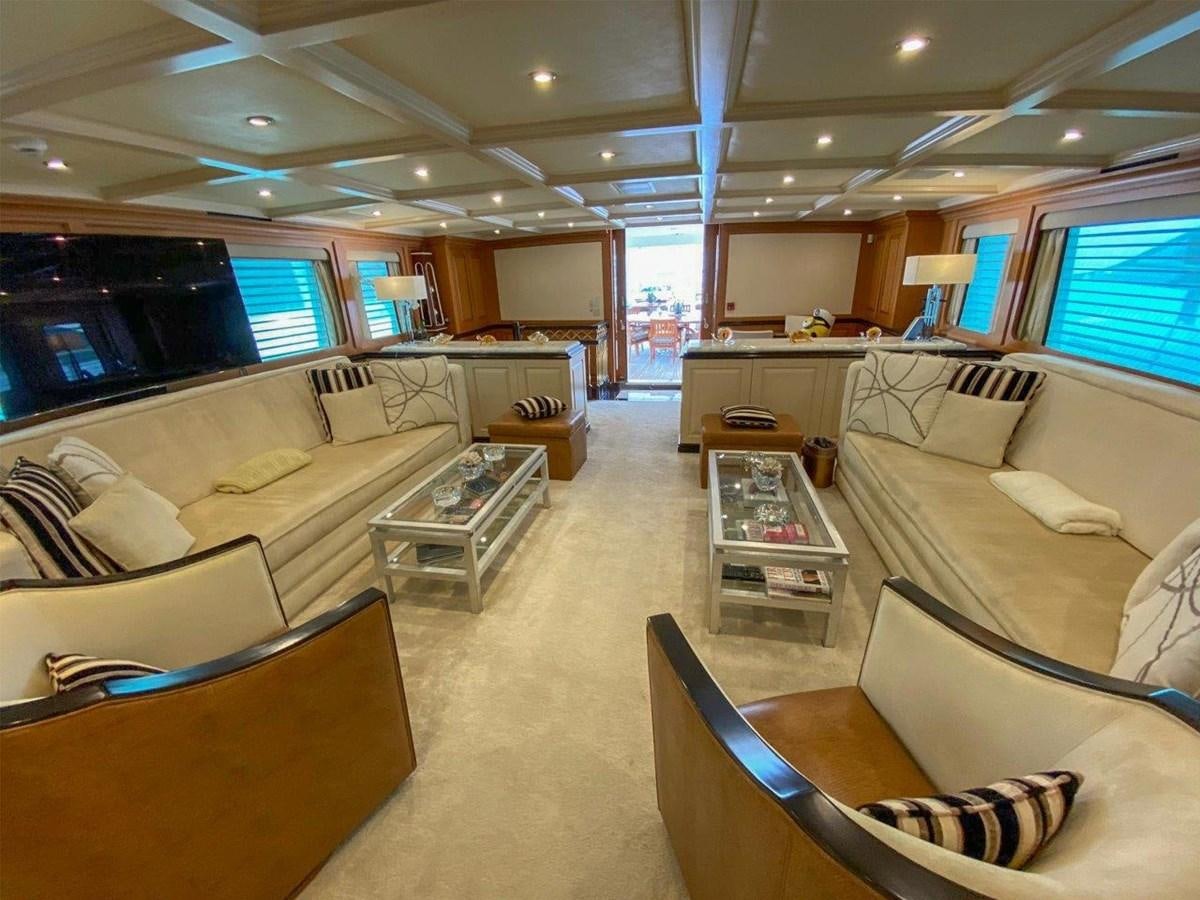 a large room with couches and a table aboard KOKOMO NIGHTS Yacht for Sale