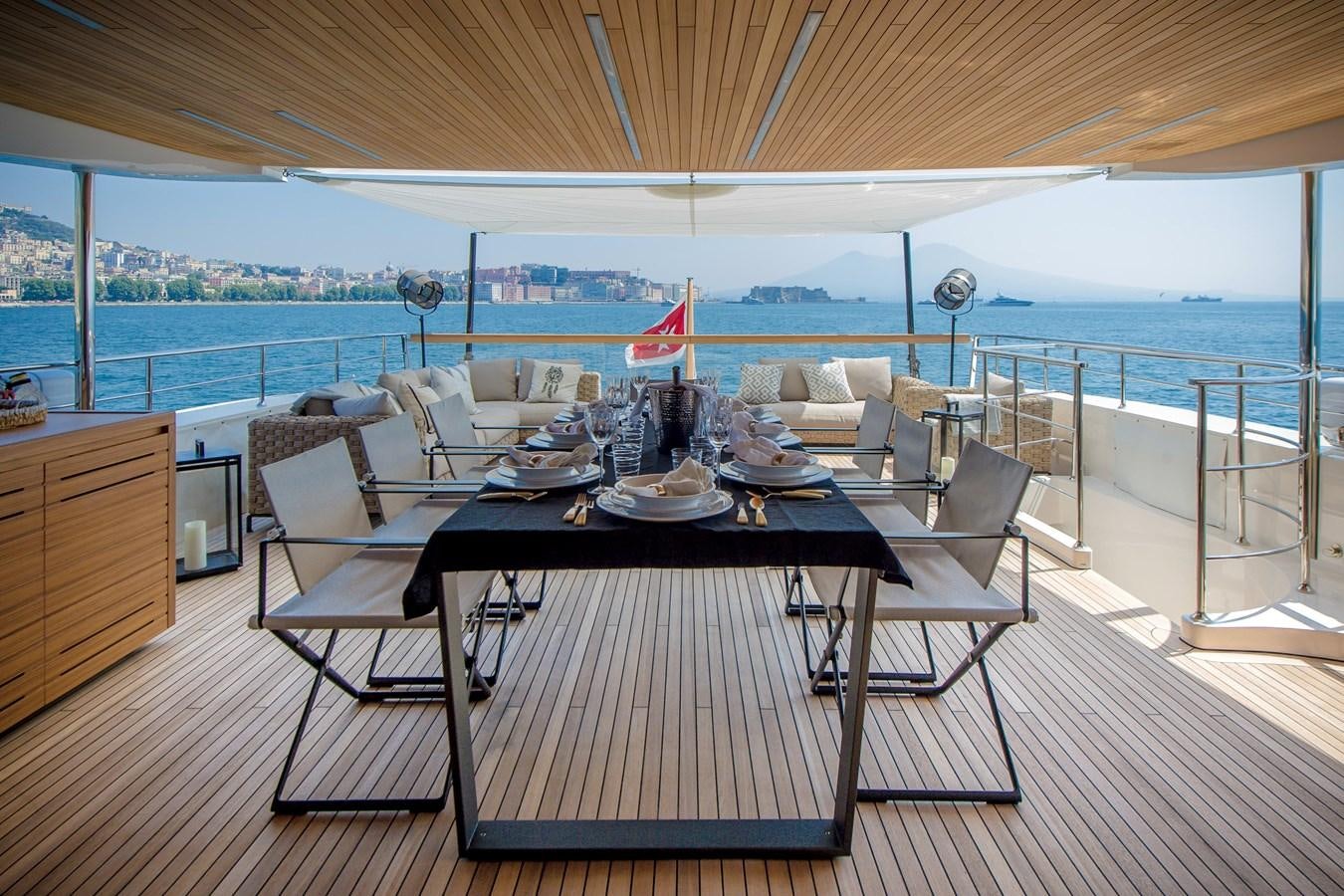 a dining table on a deck aboard SANLORENZO SD112 Yacht for Sale