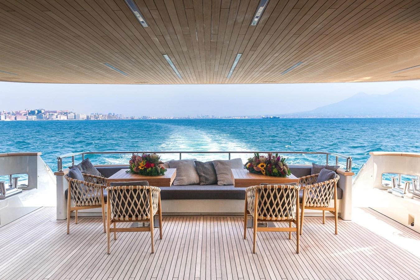 a large patio with a couch and a table and chairs aboard SANLORENZO SD112 Yacht for Sale