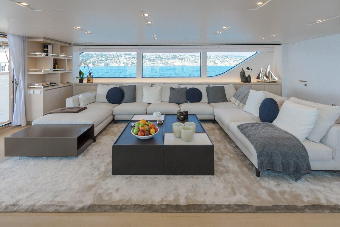 a living room with a large sofa and a coffee table aboard SANLORENZO SD112 Yacht for Sale