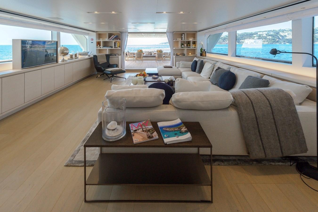 a living room with a couch and coffee table aboard SANLORENZO SD112 Yacht for Sale