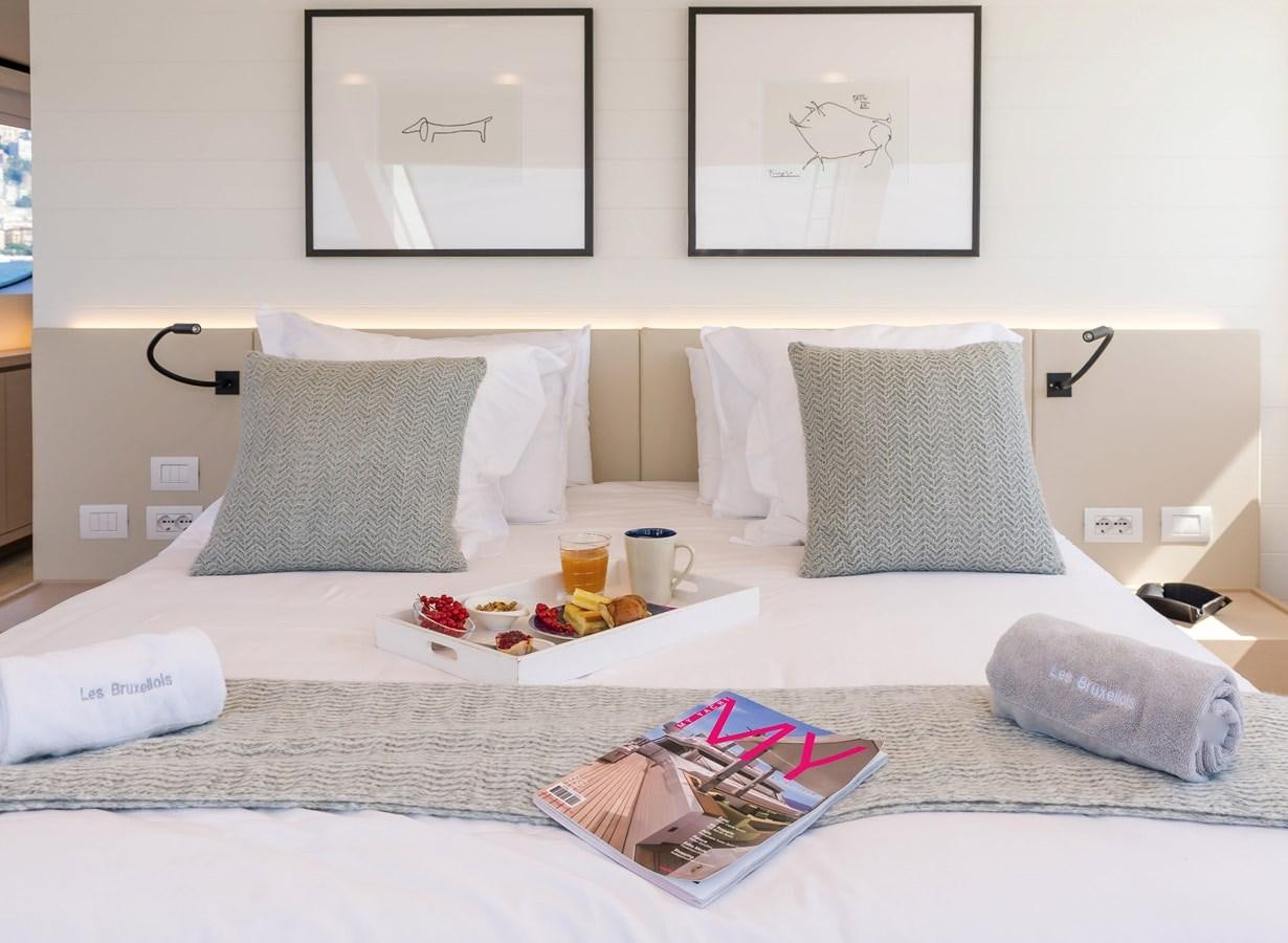 a bed with pillows and a tray of food on it aboard SANLORENZO SD112 Yacht for Sale