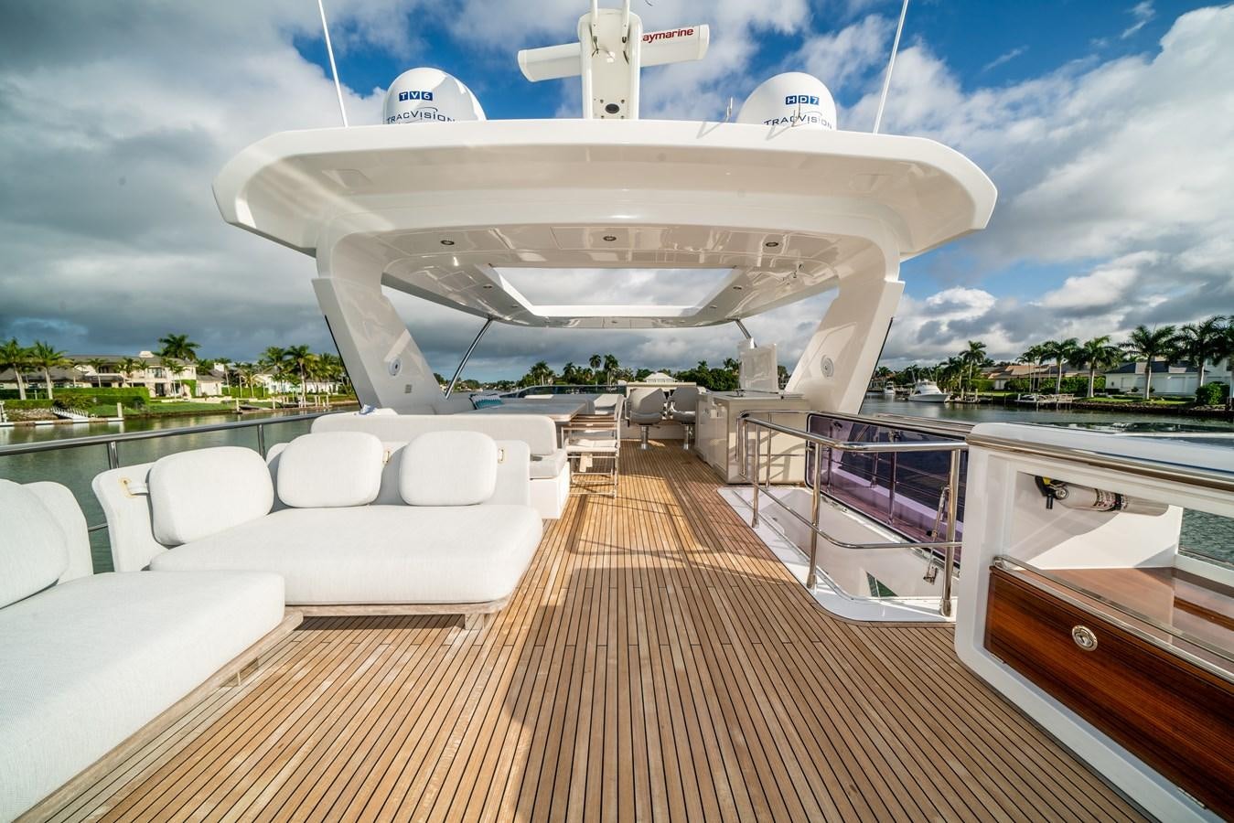 a deck with a large white building and a pool aboard CIAO BELLA Yacht for Sale