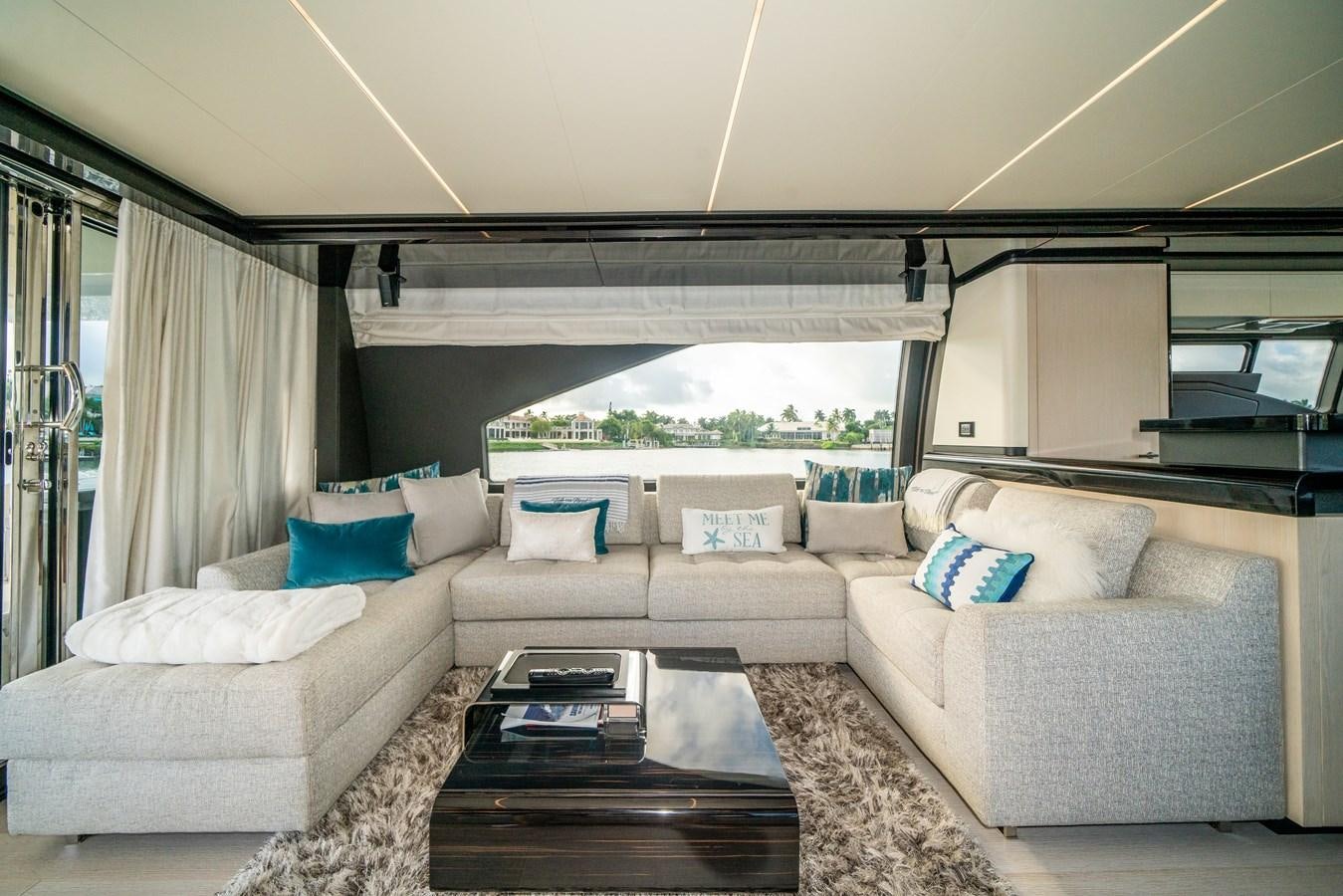 a living room with a couch and a table aboard CIAO BELLA Yacht for Sale