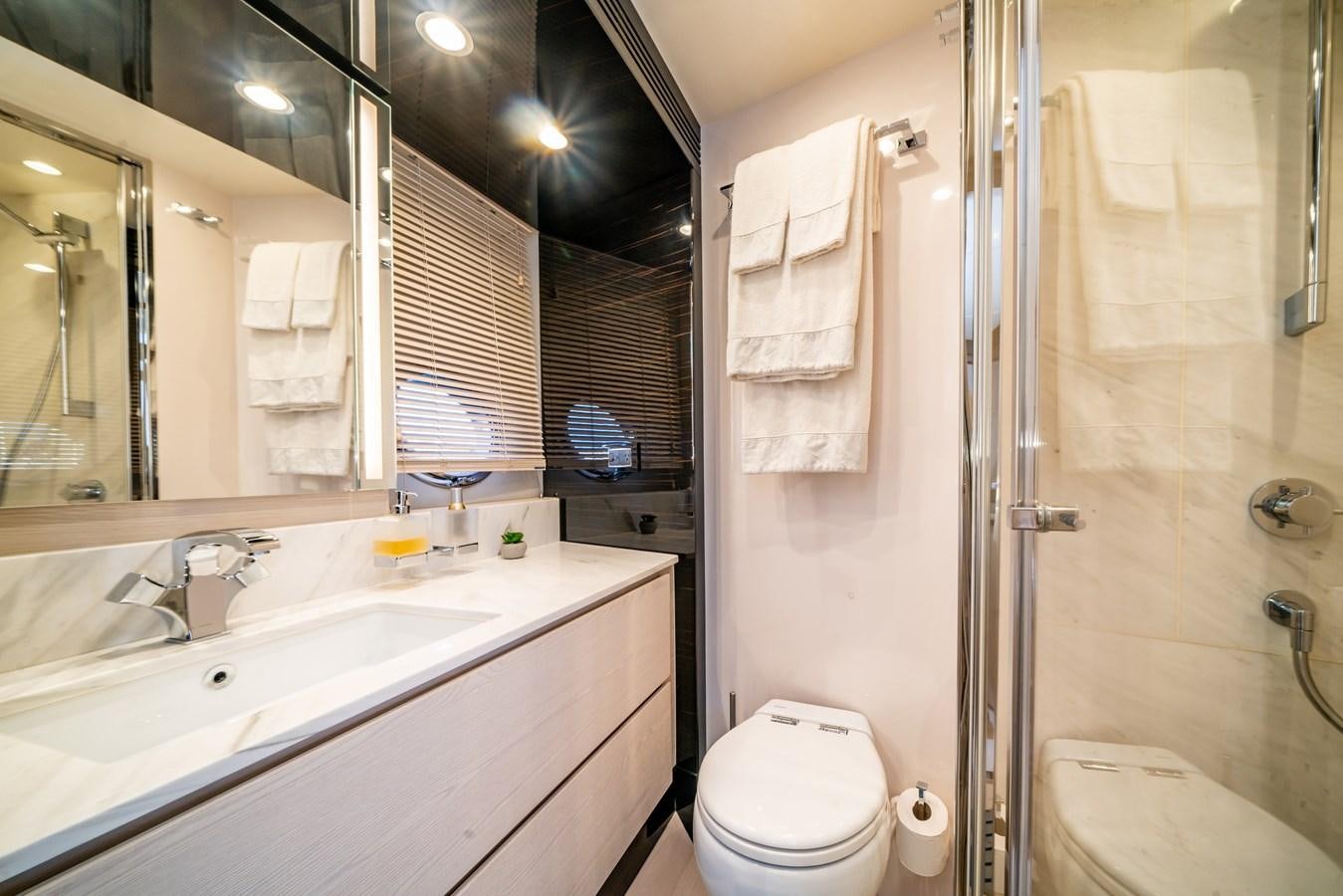 a bathroom with a sink toilet and bathtub aboard CIAO BELLA Yacht for Sale