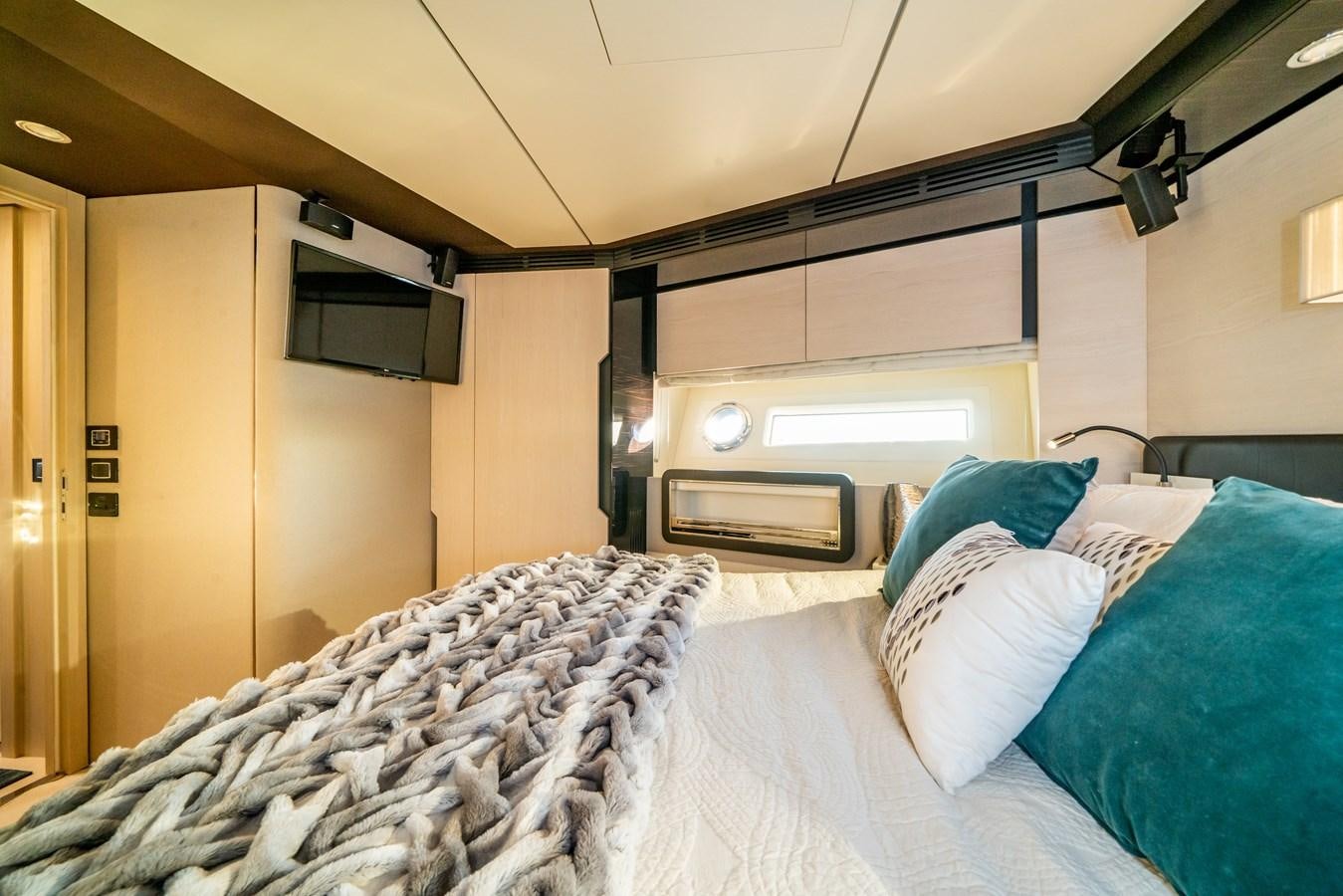 a room with a bed and a television aboard CIAO BELLA Yacht for Sale