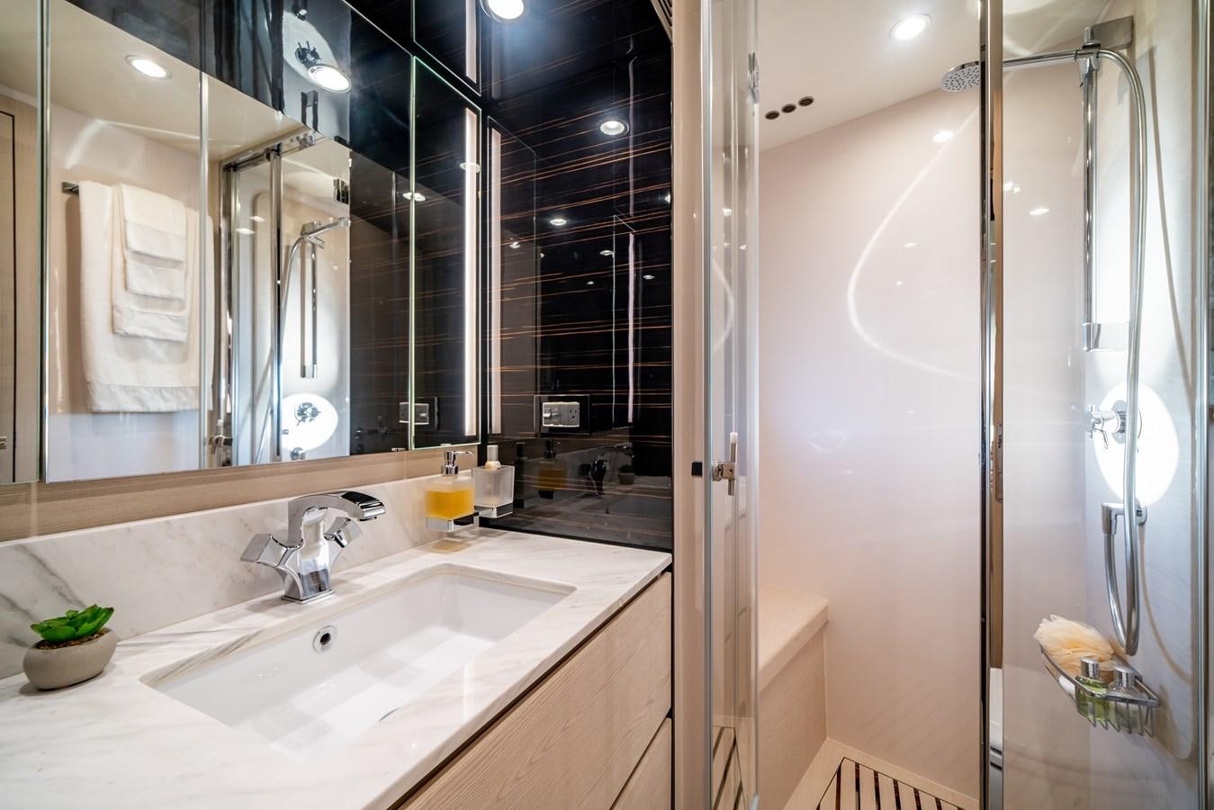 a bathroom with a large mirror aboard CIAO BELLA Yacht for Sale
