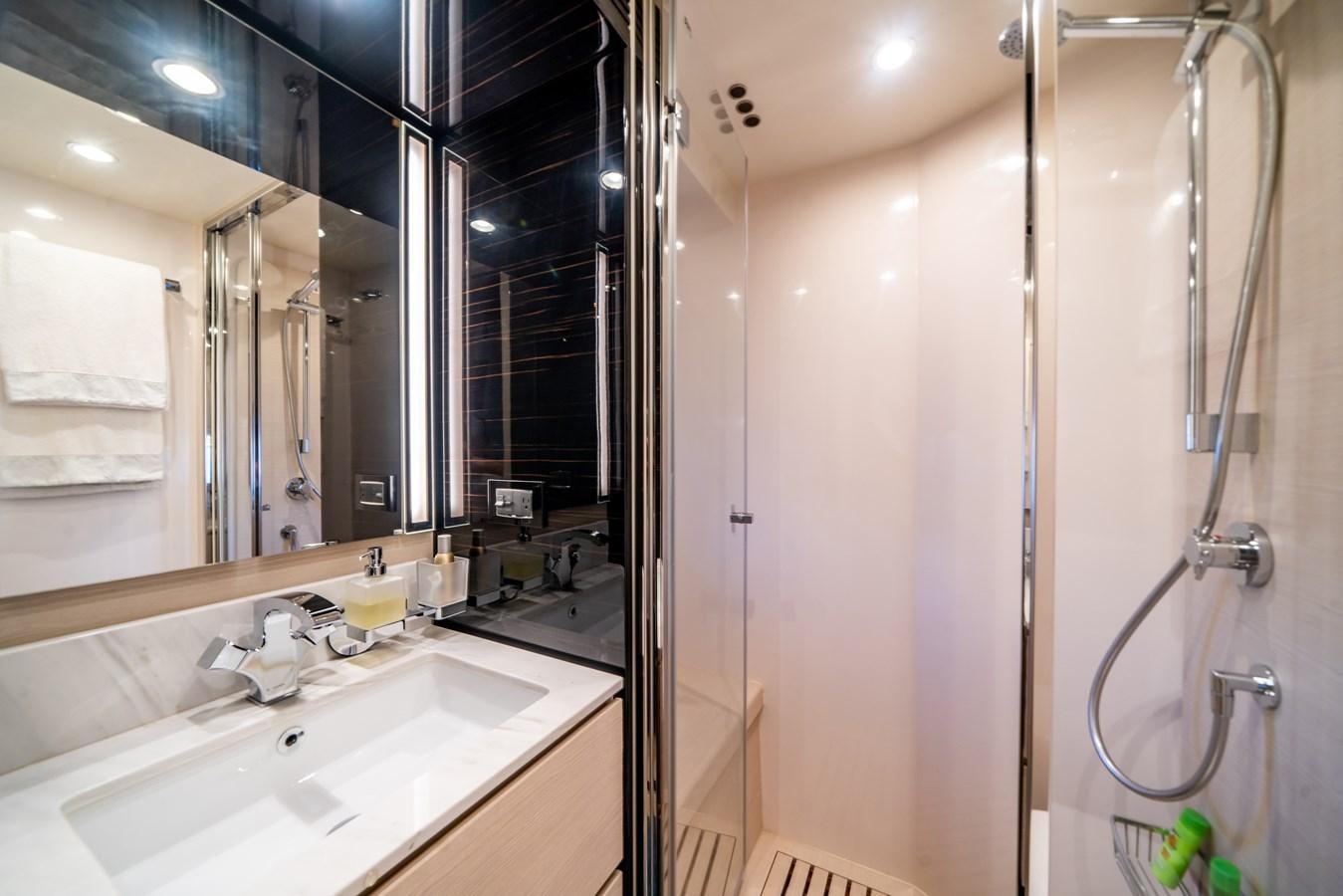a bathroom with a shower and sink aboard CIAO BELLA Yacht for Sale
