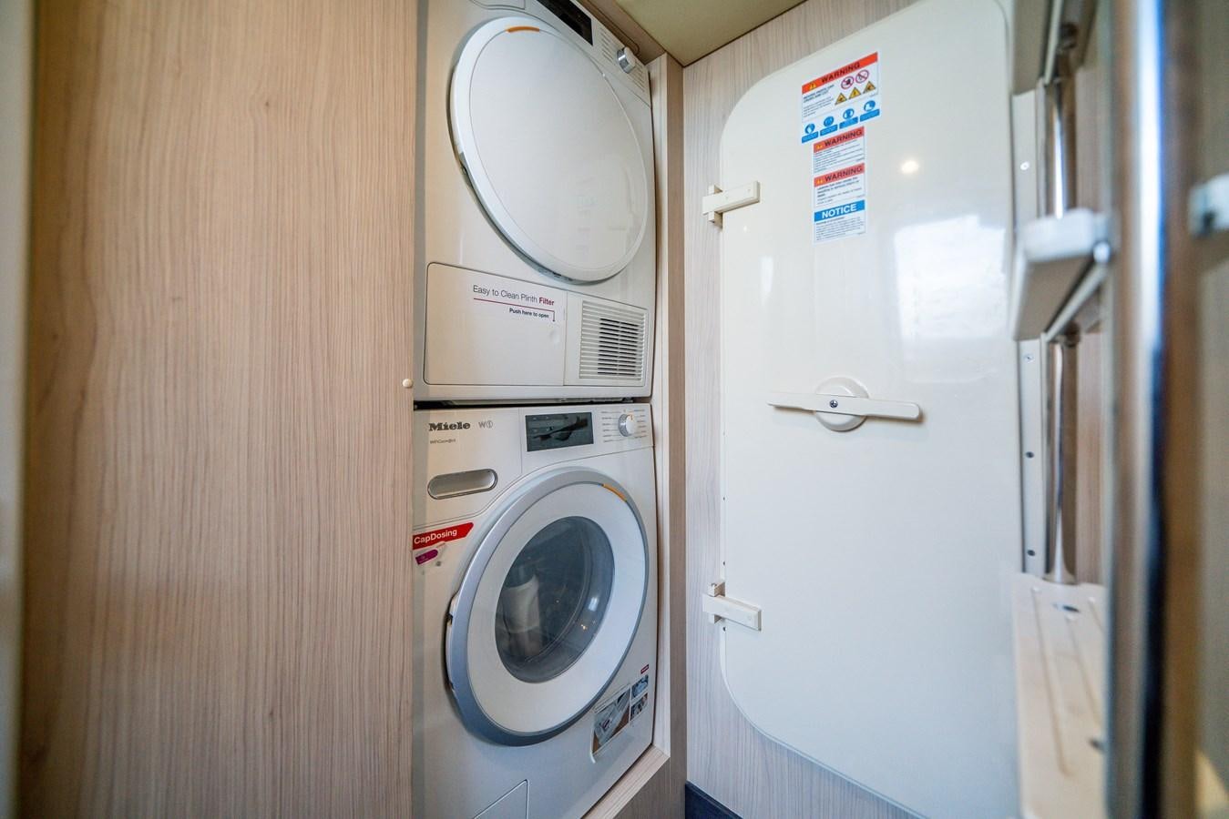 a washer and dryer in a closet aboard CIAO BELLA Yacht for Sale