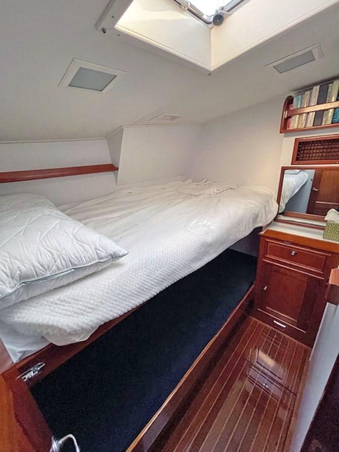 a bed with white sheets aboard SIROCCO Yacht for Sale