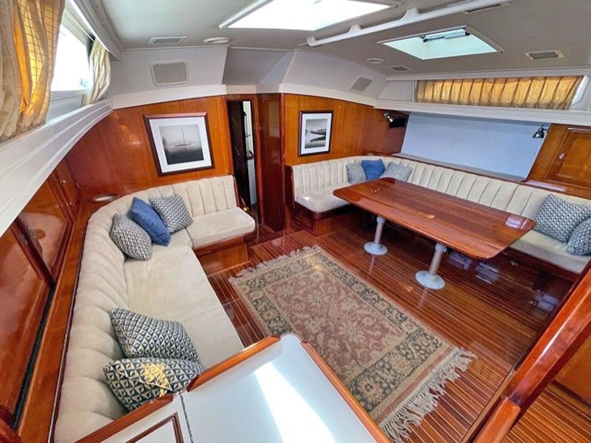 a room with a couch and a table aboard SIROCCO Yacht for Sale