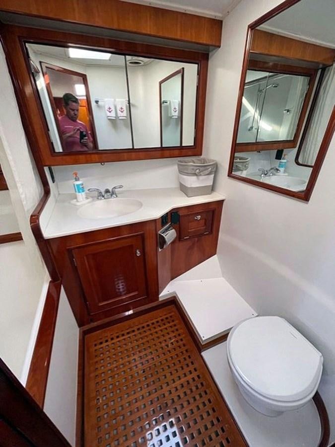 a bathroom with a mirror and a toilet aboard SIROCCO Yacht for Sale