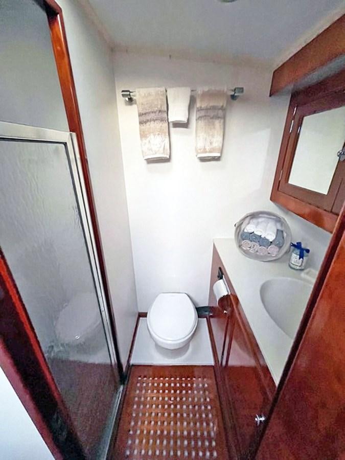 a bathroom with a sink toilet and a mirror aboard SIROCCO Yacht for Sale