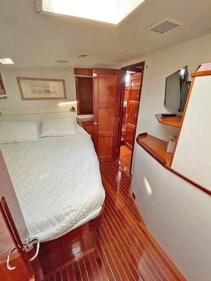a bedroom with a bed and a television aboard SIROCCO Yacht for Sale