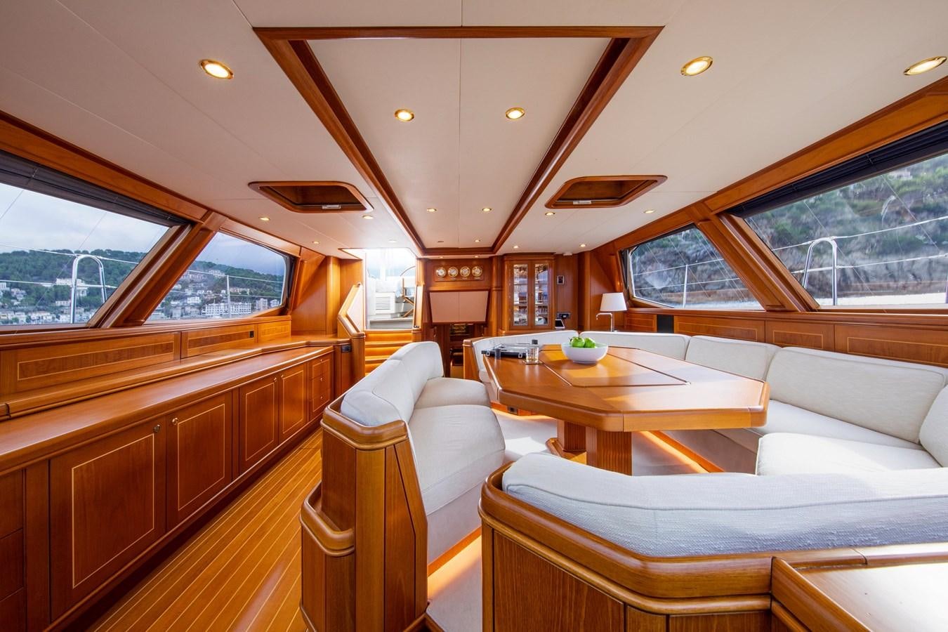 a living room with a table and couches aboard MYSTERY Yacht for Sale