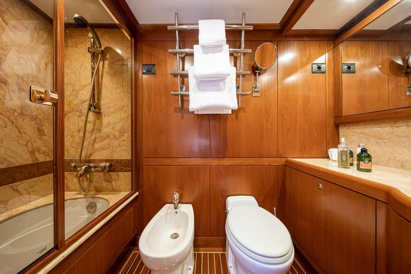a bathroom with a toilet and a bathtub aboard MYSTERY Yacht for Sale