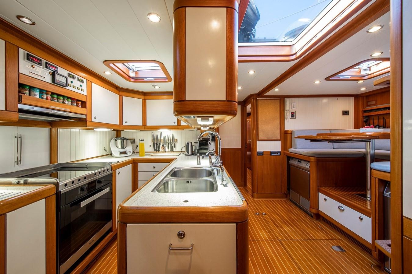 a kitchen with wooden cabinets aboard MYSTERY Yacht for Sale