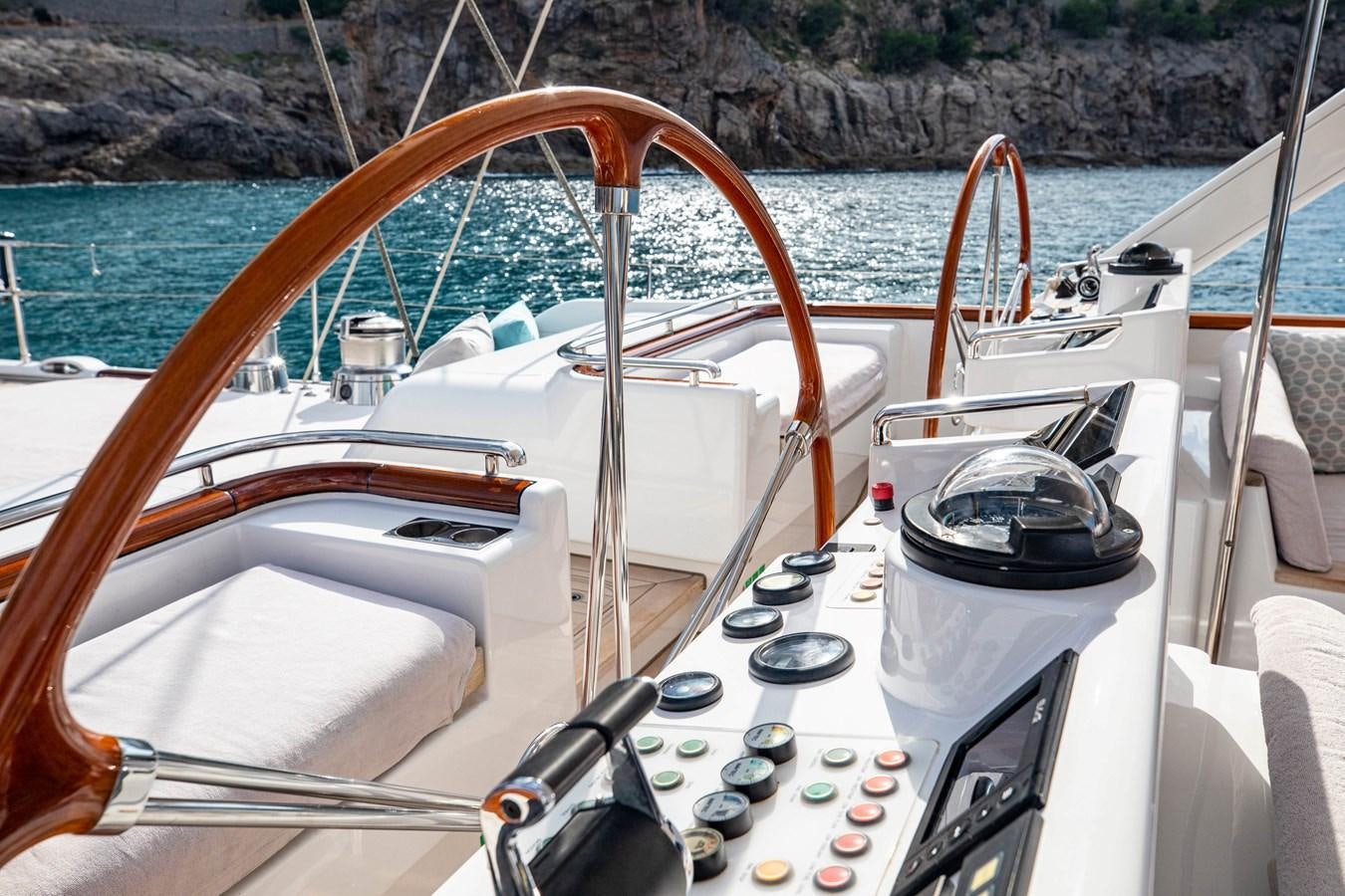 a boat with a steering wheel and a wood steering wheel aboard MYSTERY Yacht for Sale