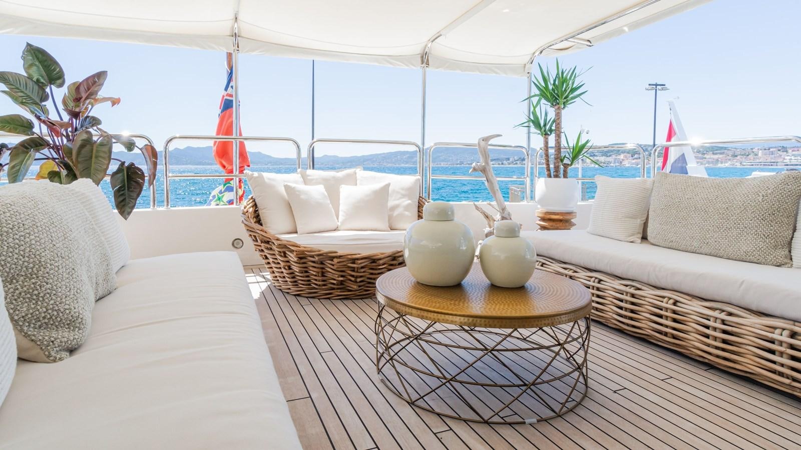 a living room with a large white tent and a table with a vase on it aboard GIORGIA Yacht for Sale