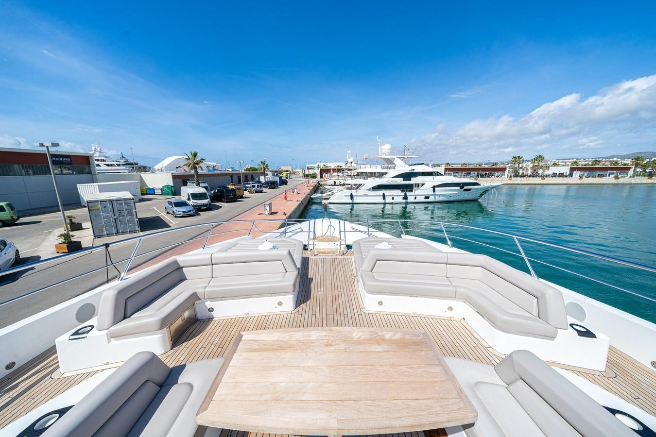 a deck with a boat and a dock with a city in the background aboard SUNSEEKER 116 -  QART HADASHT Yacht for Sale