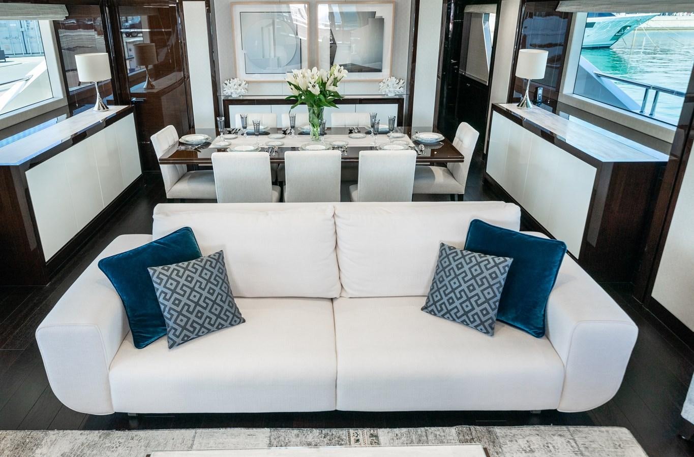 a white couch with blue pillows aboard SUNSEEKER 116 -  QART HADASHT Yacht for Sale