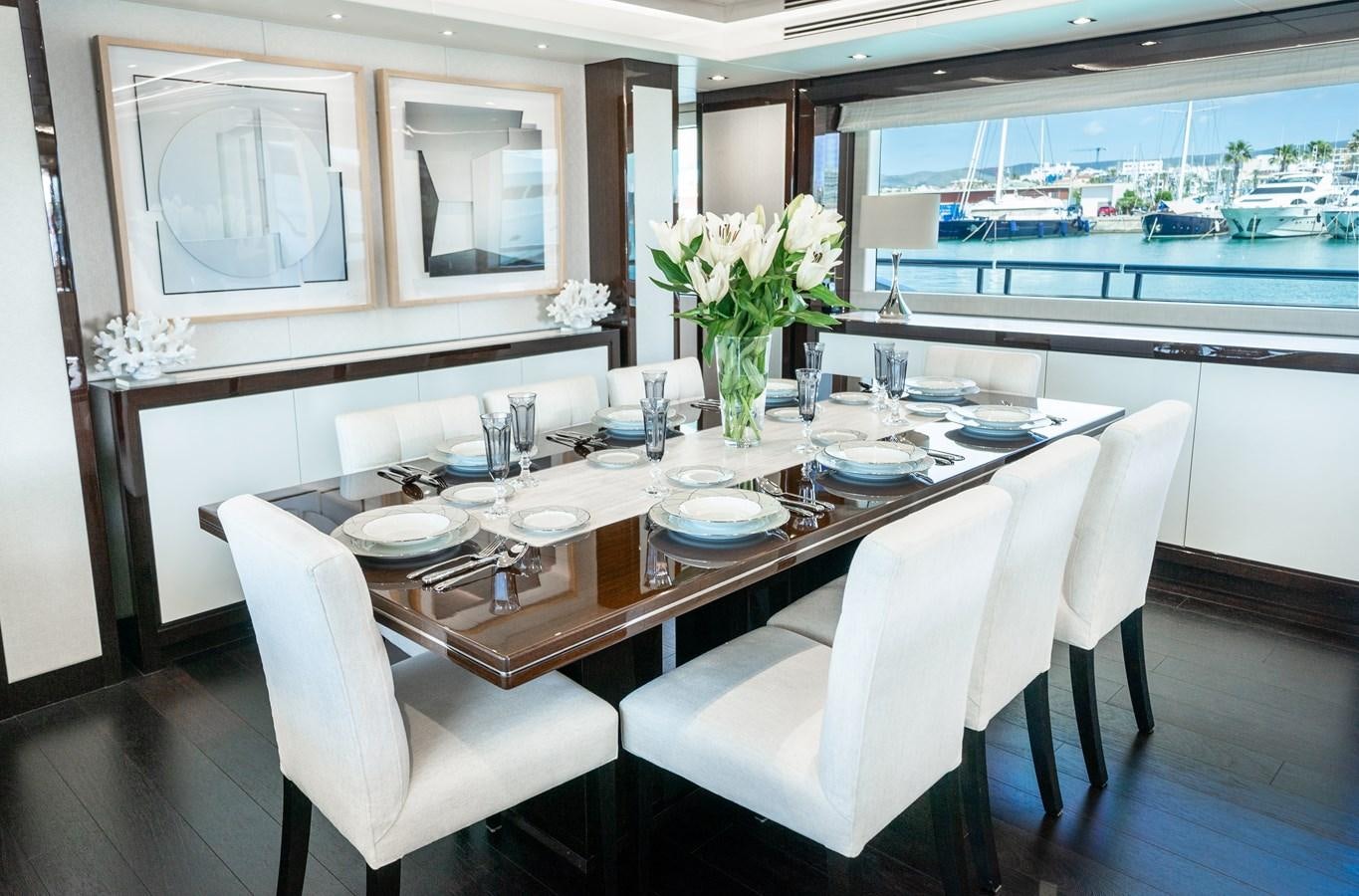 a dining table with white chairs aboard SUNSEEKER 116 -  QART HADASHT Yacht for Sale