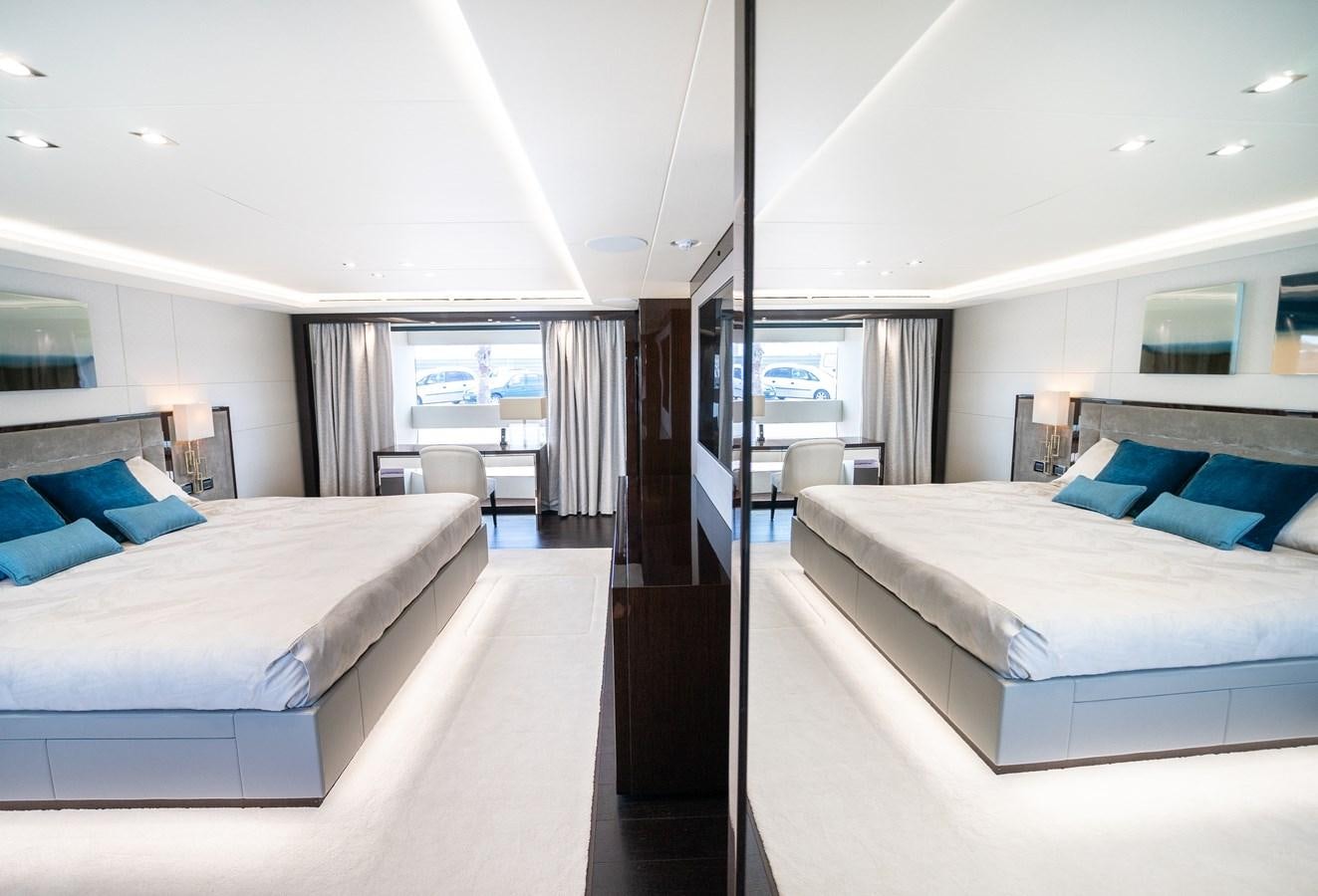 a room with a bed and a window aboard SUNSEEKER 116 -  QART HADASHT Yacht for Sale