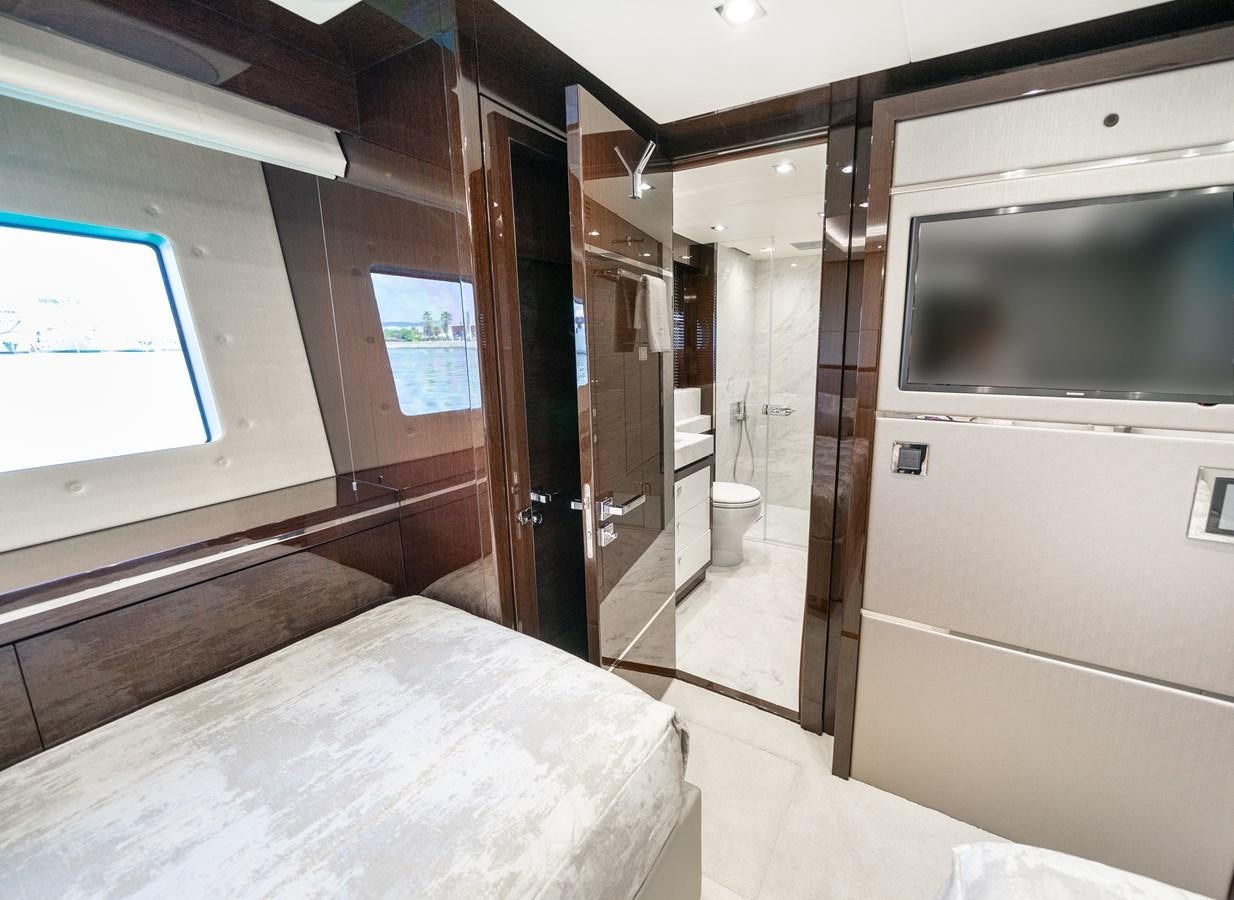 a room with a bed and a window aboard SUNSEEKER 116 -  QART HADASHT Yacht for Sale