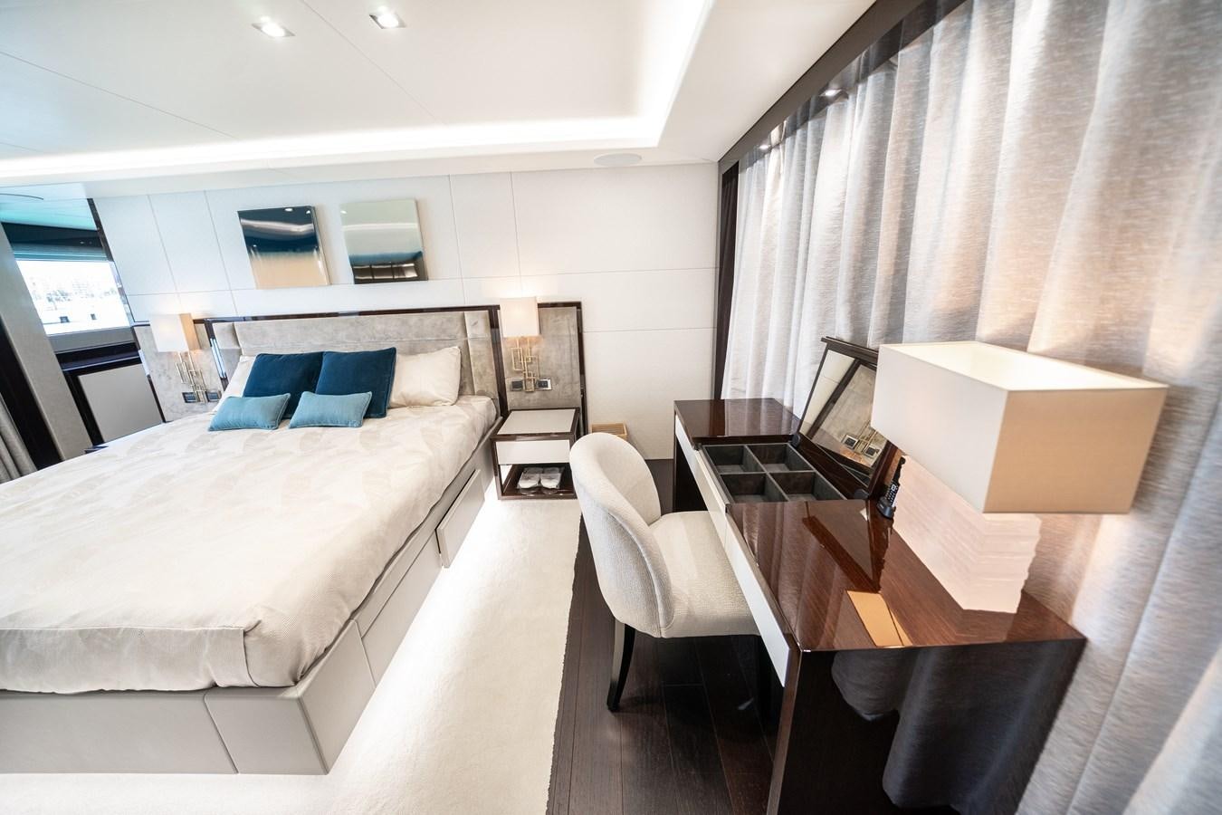 a room with a bed and desk aboard SUNSEEKER 116 -  QART HADASHT Yacht for Sale