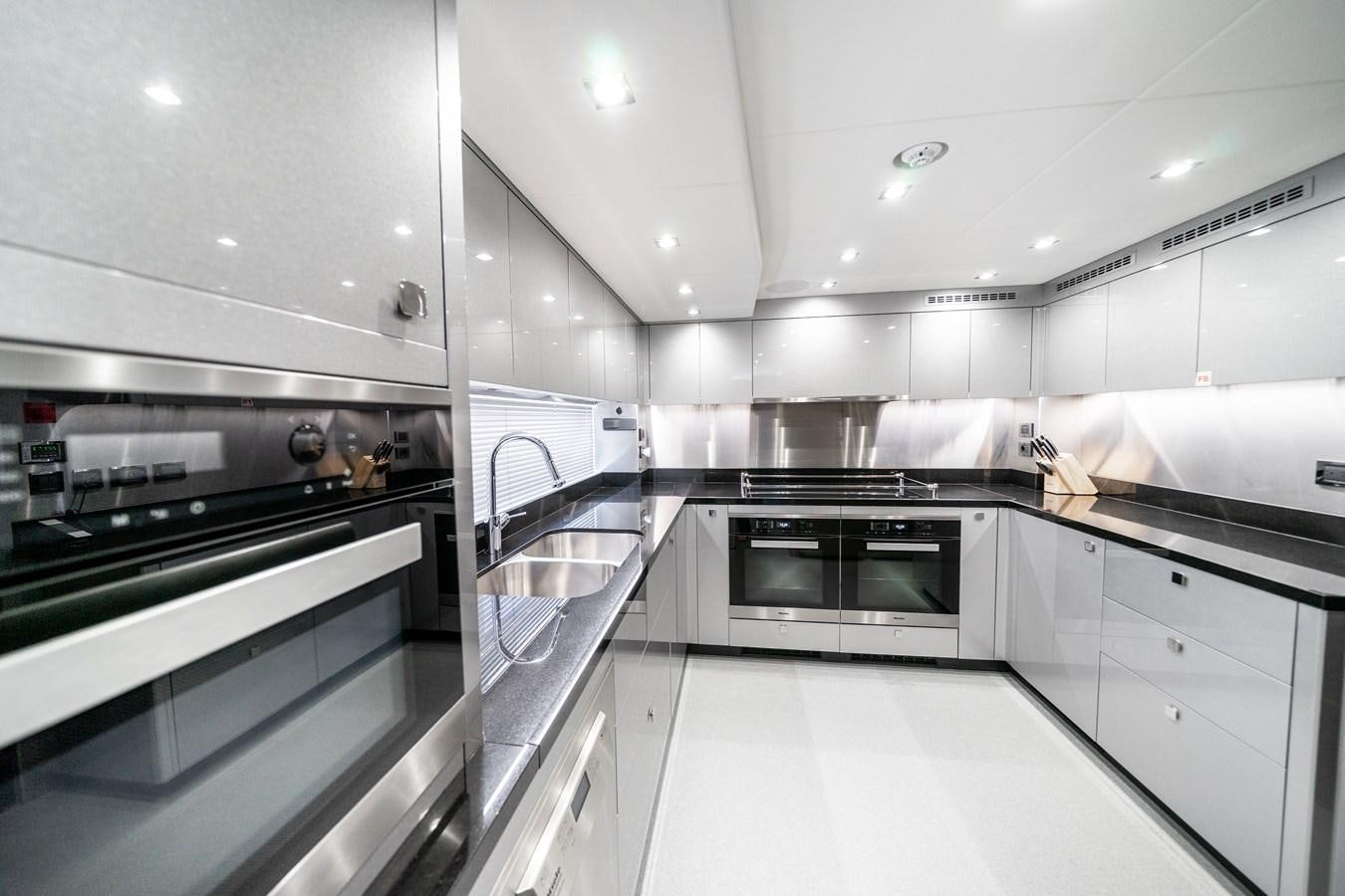 a kitchen with white cabinets aboard SUNSEEKER 116 -  QART HADASHT Yacht for Sale