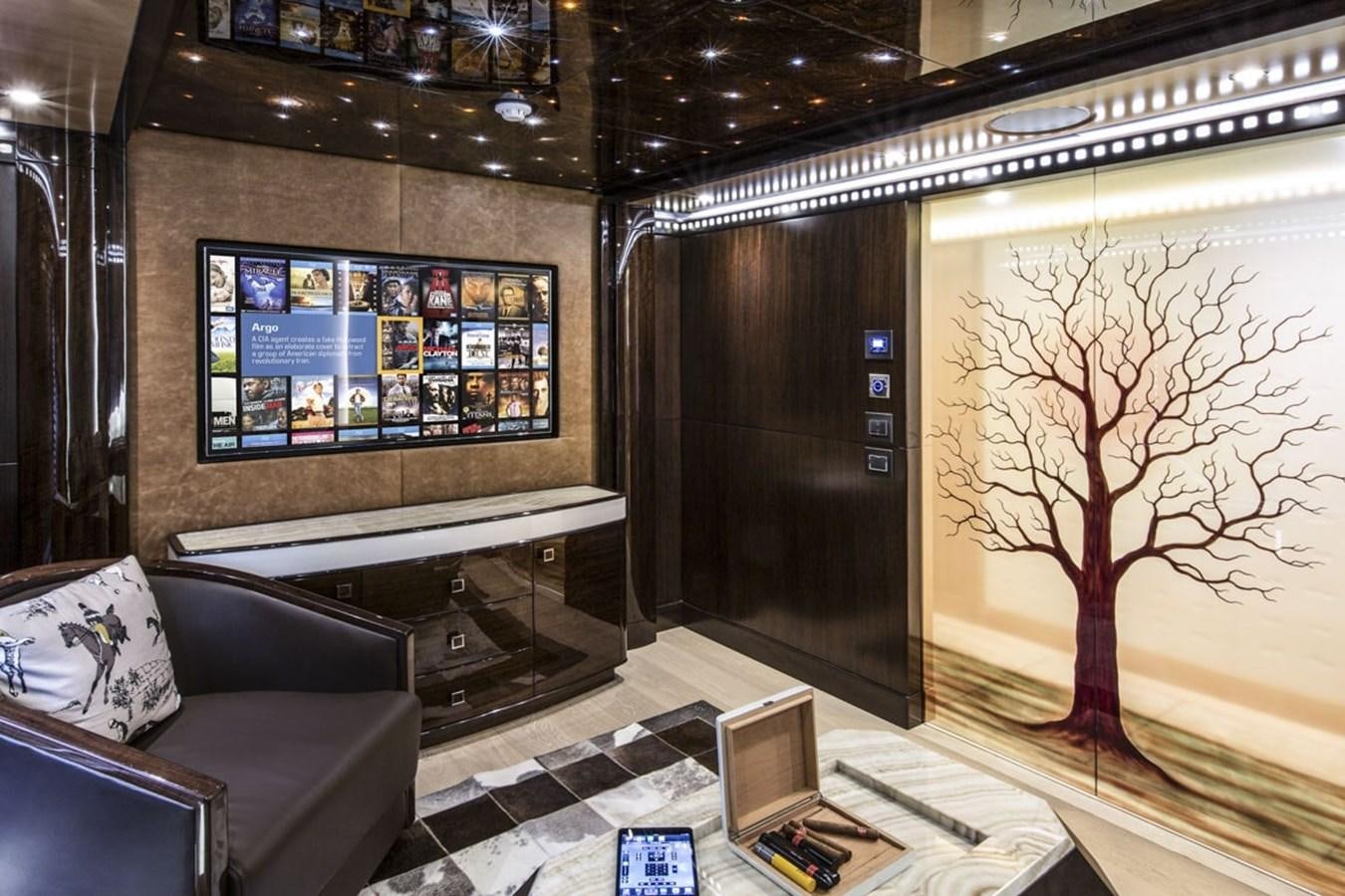 a living room with a large screen aboard MAJESTY 155 Yacht for Sale