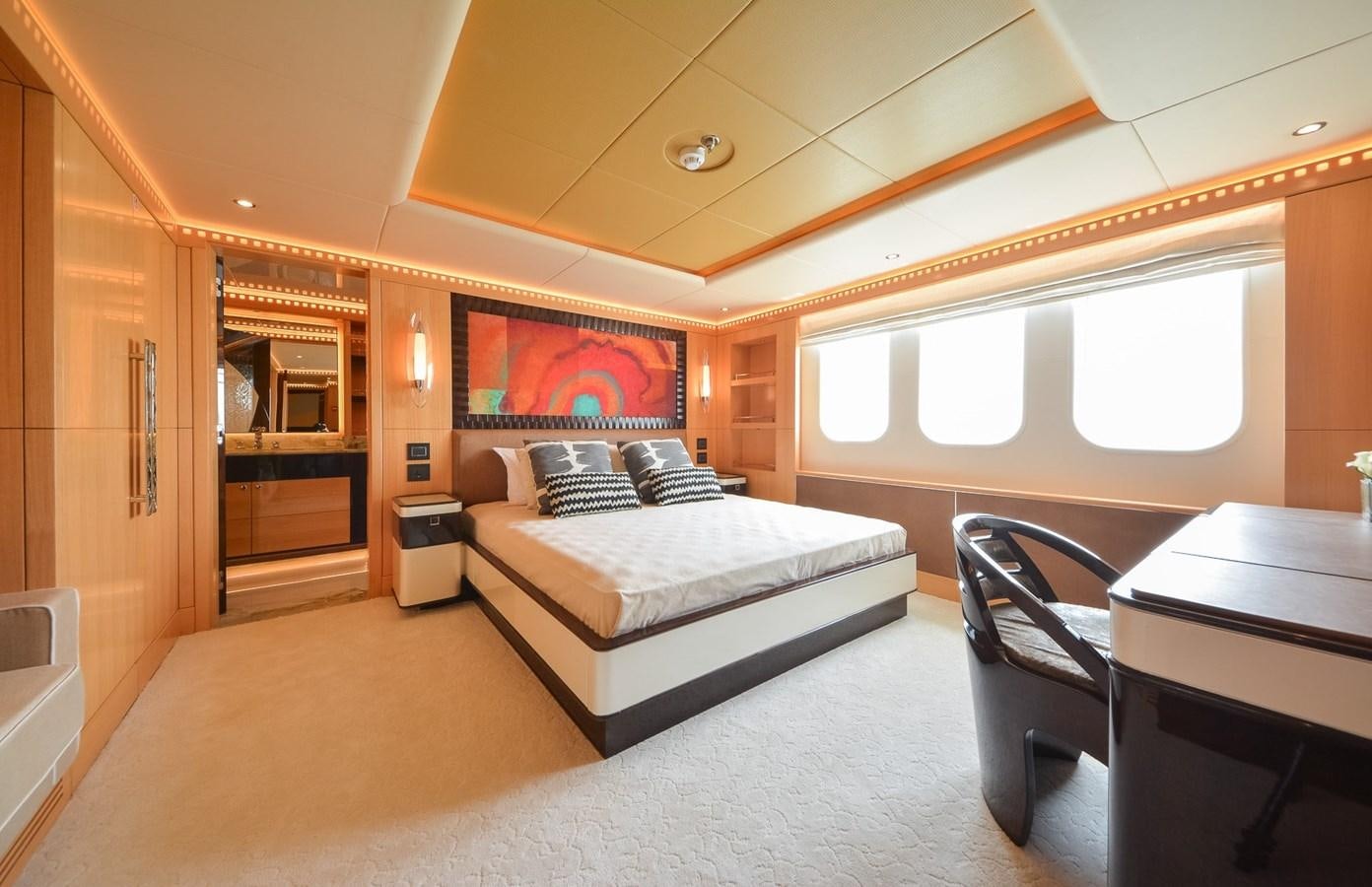 a bedroom with a bed and a desk aboard MAJESTY 155 Yacht for Sale
